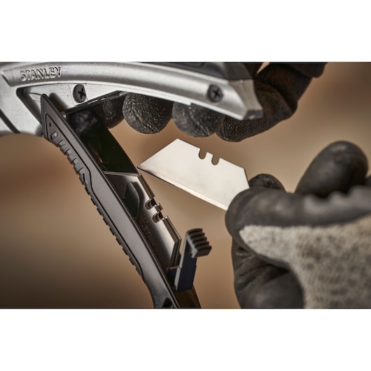 STANLEY 0-10-788 utility knife open, blade removal close-up, photographed with gloves.