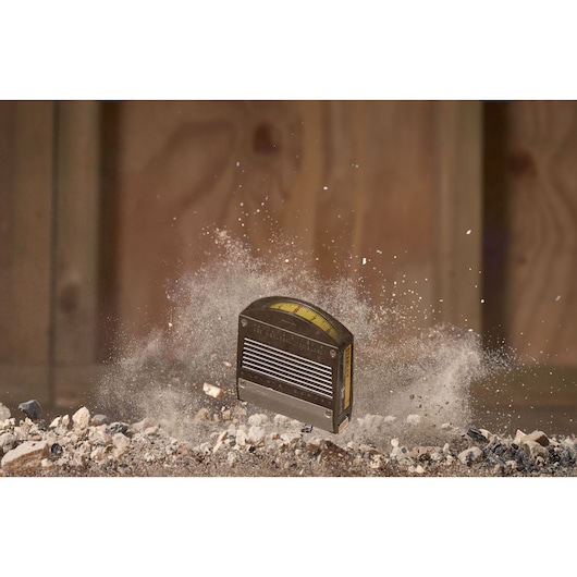 STANLEY 0-32-125 tape measure photography, close-up with dust and debris in construction setting.