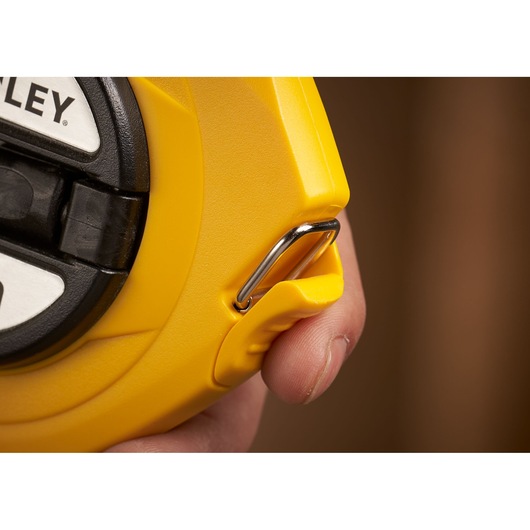 STANLEY 0-34-102 tape measure close-up showing yellow casing and metal clip.