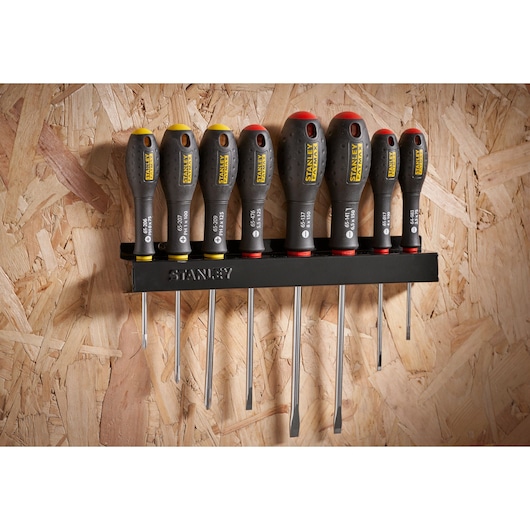Photo of STANLEY 0-65-437 screwdriver set with black and yellow handles, stored on a wall-mounted rack.