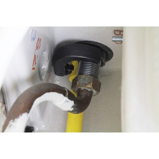 STANLEY 0-70-453 pipe cutter close-up on metal pipe with threaded joint and yellow hose.
