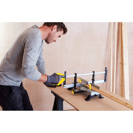 Stanley 1-20-800 hand saw in miter box cutting wood, photo of tool in use on workbench.