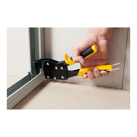 Photo of STANLEY 1-69-100 hand-operated metal pliers used on drywall corner frame, close-up angle.