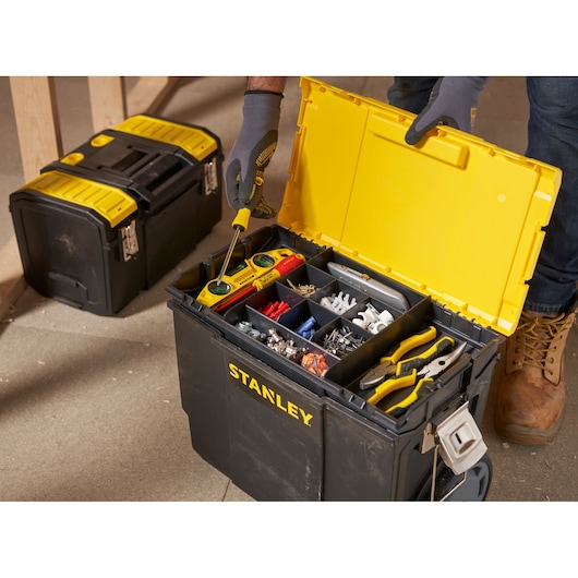 Photo of STANLEY 1-70-326 black and yellow tool box with open lid showing compartments filled with tools and hardware.