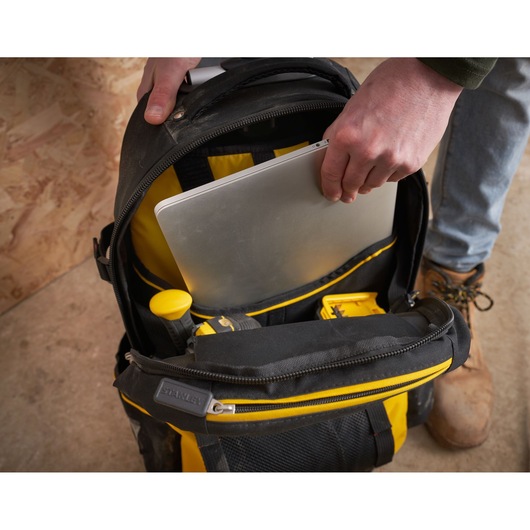 STANLEY 1-79-215 photography of black and yellow backpack with laptop and tools in main compartment.