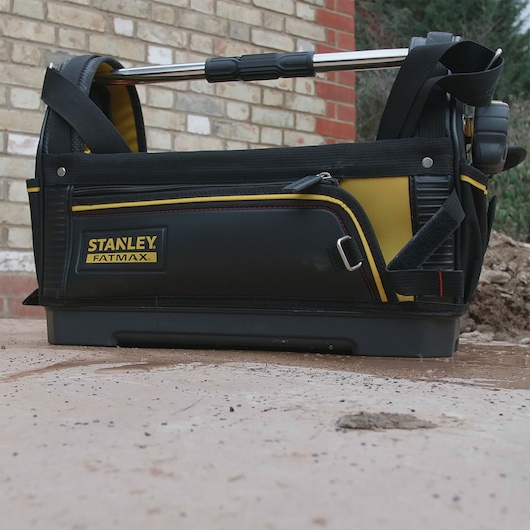 STANLEY 1-93-951 photography of FATMAX tool bag, black and yellow, side view, outdoor setting.