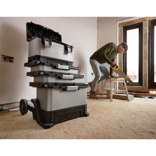 Photo of STANLEY 1-95-622 rolling tool chest stack in a workshop, showing four grey and black toolboxes with wheels.