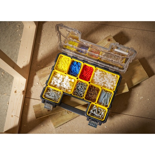 STANLEY 1-97-517 organiser box with assorted fasteners photographed from above on workshop floor.