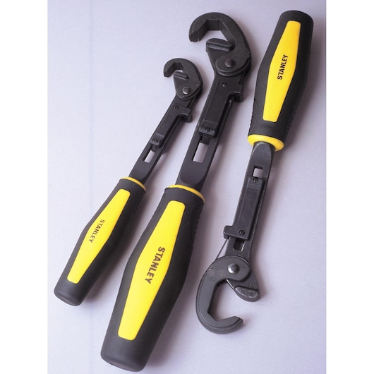 STANLEY 4-87-988 set of three adjustable wrenches with black metal jaws and yellow-black handles, angled view.