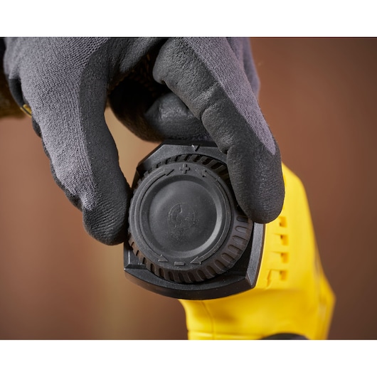 STANLEY 6-TRE550 photography of yellow tool close-up showing adjustment dial held by gloved hand.