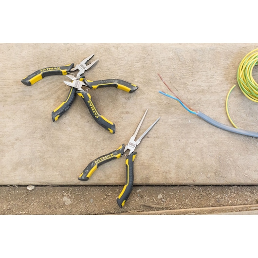 STANLEY FMHT0-80524 pliers set with yellow and black handles on a work surface with electrical wires.