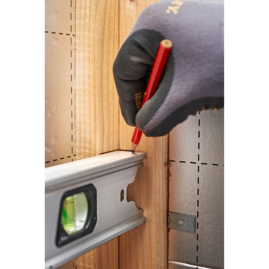 STANLEY FMHT43670-1 spirit level in use marking a line on wood, close-up angle.
