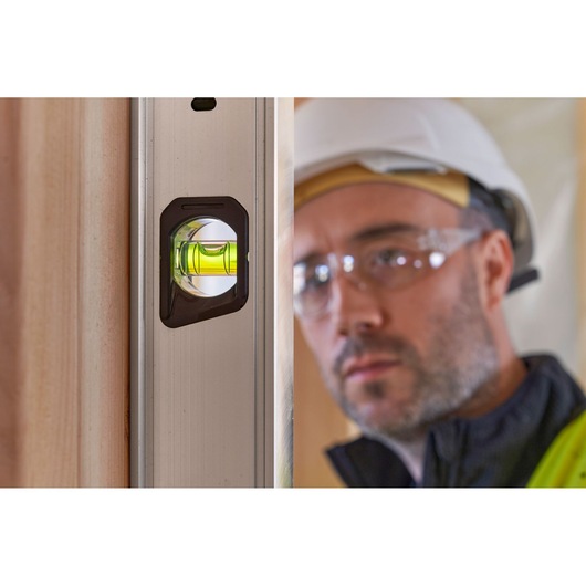 STANLEY FMHT43680-1 photography of a spirit level with green vial on vertical surface, close-up angle.