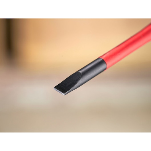 Close-up of a flathead screwdriver with a black tip and red handle.