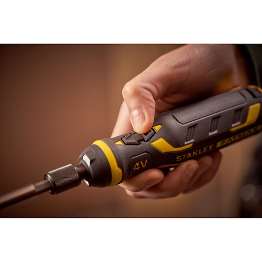 Photo of STANLEY FMHT66719-0 4V cordless screwdriver held in hand, close-up showing yellow and black design.