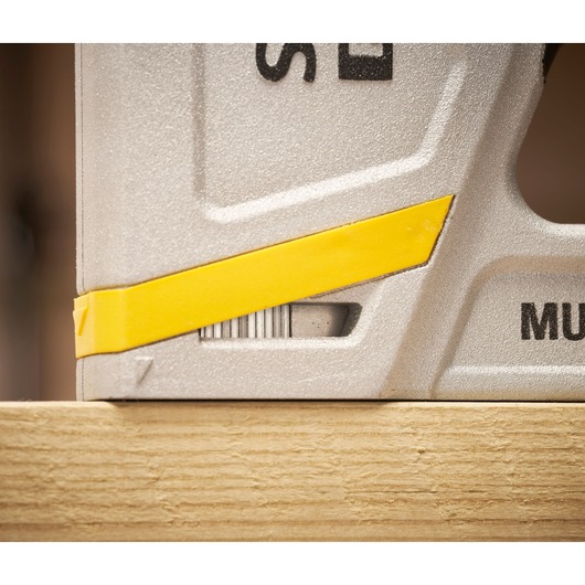 STANLEY FMHT70443-0 photography of silver tool with yellow accent resting on wood, close-up angle.