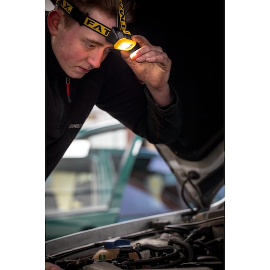 STANLEY FMHT81509-0 headlamp in use, illuminating engine compartment during automotive inspection.