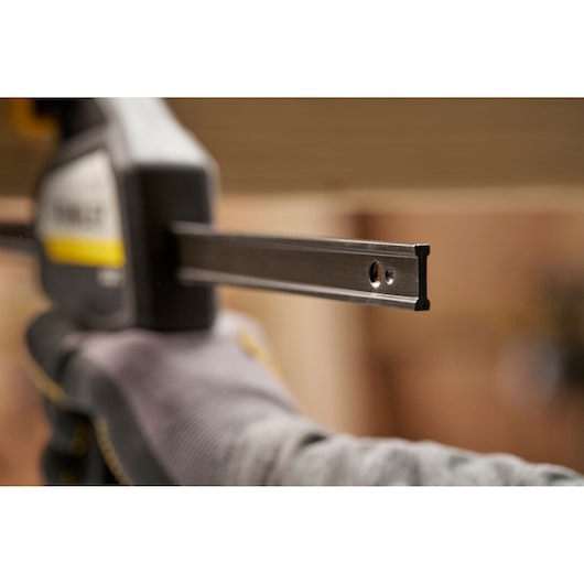 STANLEY FMHT83273-0 photography of clamp bar end held by gloved hand in workshop setting.