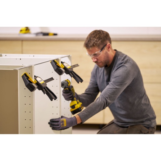 Photo of STANLEY FMHT83279-0 clamp used to secure cabinet parts during assembly, side angle view.