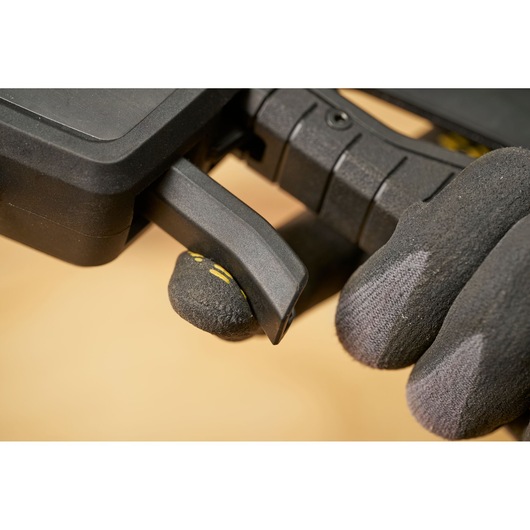 STANLEY FMHT83280-0 photography close-up of black plastic trigger clamp held by gloved hand.
