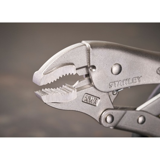 Close-up of STANLEY locking pliers with serrated jaws, metal finish, suitable for gripping objects tightly.