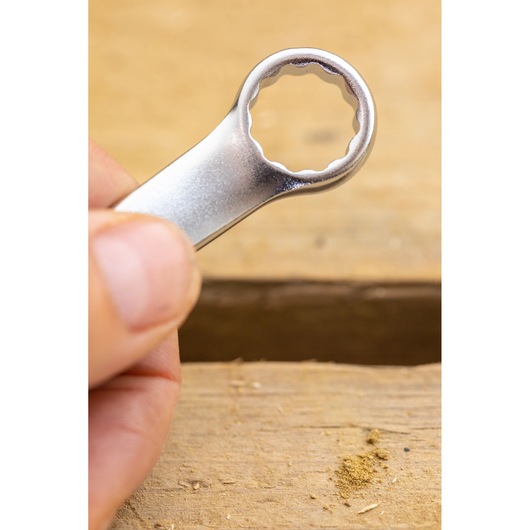 Stanley FMMT13040-0 box end wrench close-up, silver finish, held by hand, photography category.