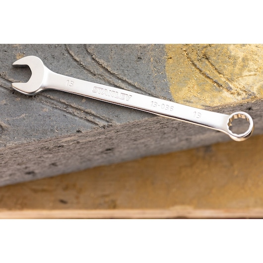 STANLEY FMMT13042-0 combination wrench in silver finish, placed on textured concrete surface.