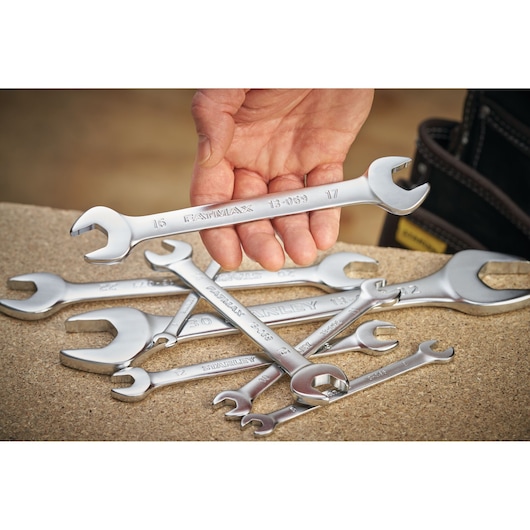 STANLEY FMMT13073-0 photography of open-end wrenches, one held in hand, several on work surface.
