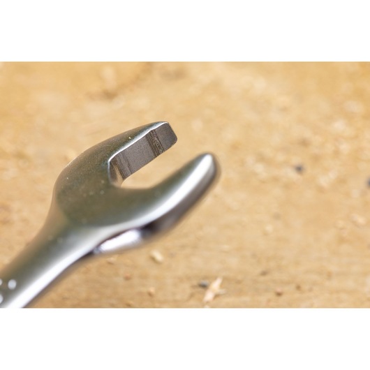 STANLEY FMMT13095-0 Photography of an open-end wrench close-up on a wooden surface.