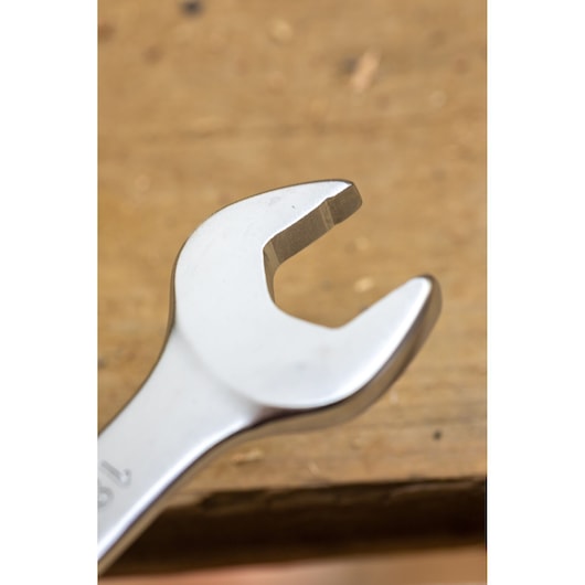 STANLEY FMMT13095-0 open-end wrench close-up photo, silver finish, on a wooden surface.