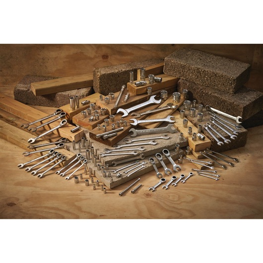 STANLEY FMMT13095-0 wrench and socket set displayed on wood and concrete blocks, front angle.