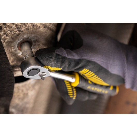 Photo of STANLEY FMMT17196-0 ratchet being used on a bolt, close-up view with gloved hand.