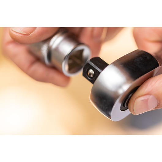STANLEY FMMT17223-0 hand holding metallic ratchet and socket, close-up, photography product category.