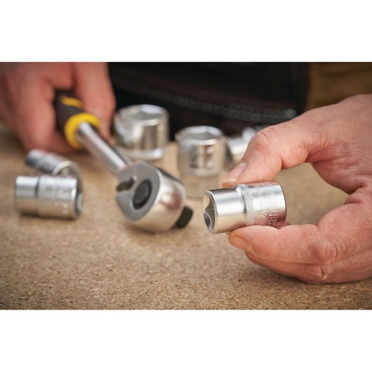 STANLEY FMMT17233-0 socket and ratchet in use, close-up photo, chrome finish, hand-held.