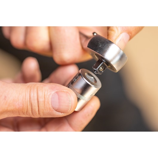 STANLEY FMMT82683-0 hand holding a ratchet wrench and socket, close-up showing attachment mechanism.
