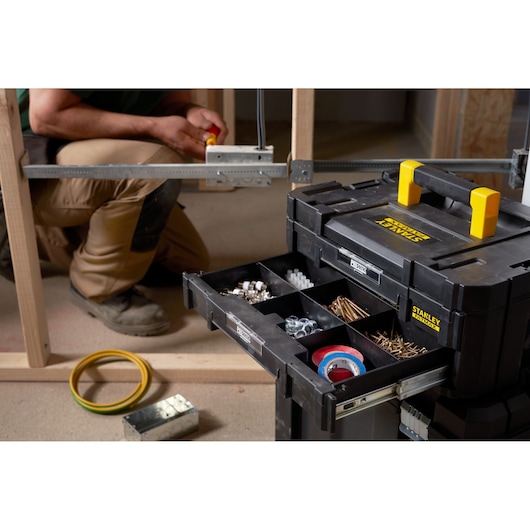 STANLEY FMST1-71969 tool organizer with open drawer showing compartments of fasteners and tape, front angle.