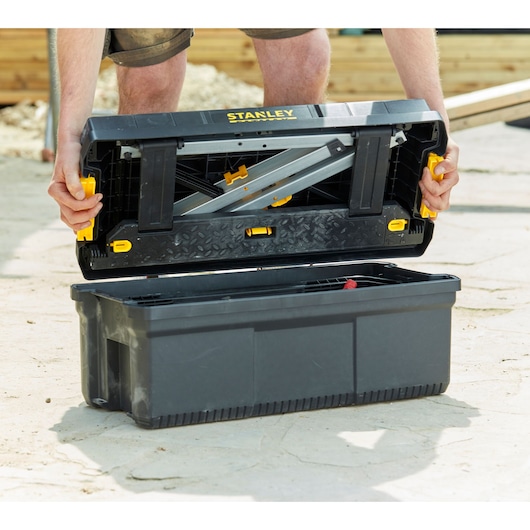 STANLEY FMST81083-1 tool box with open lid showing internal metal tray and yellow clasps.