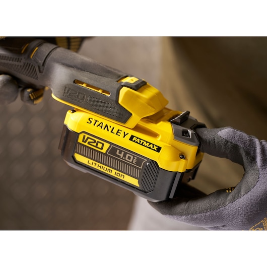 STANLEY SFMCF930B V20 4.0Ah Lithium Ion battery being attached to power tool, close-up photo.