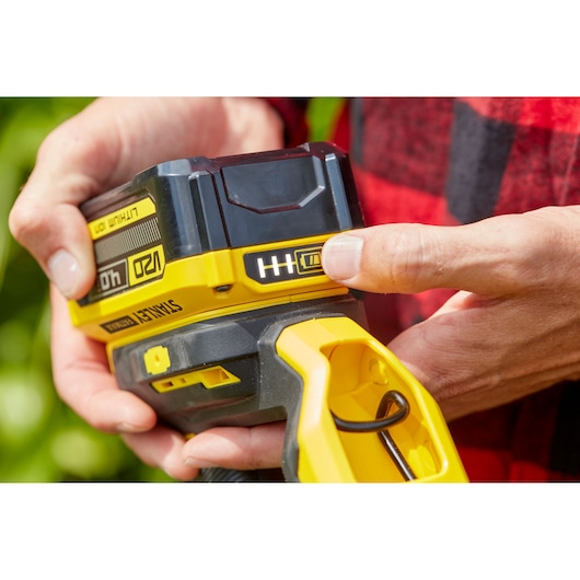 Photo of STANLEY SFMCST933M1 battery-powered tool being operated, yellow and black details visible.