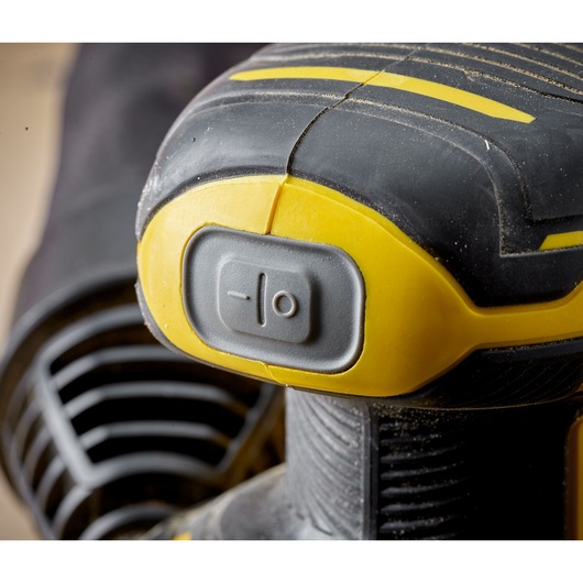 STANLEY SFMCW220B detail of yellow and black sander power switch, close-up photography.