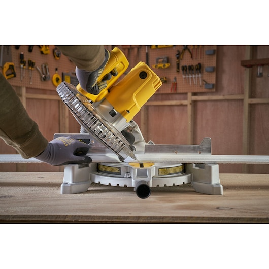 STANLEY SM1650 miter saw being used to cut metal, shown from side angle in workshop.