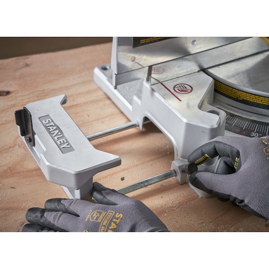 STANLEY SM1800 miter saw clamp accessory on wood surface, close-up angle.