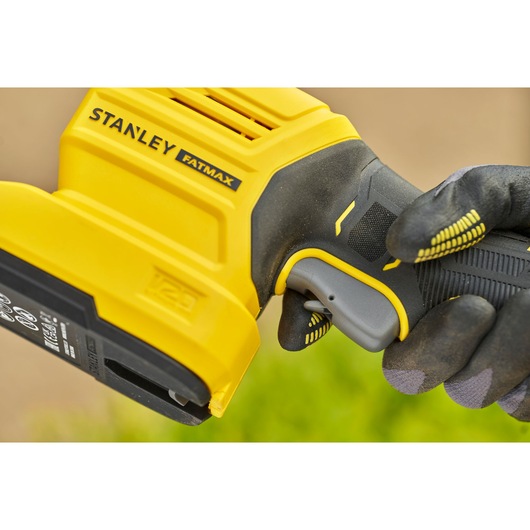 STANLEY STCSS20D1 cordless tool handle close-up held by gloved hand, yellow and black design.