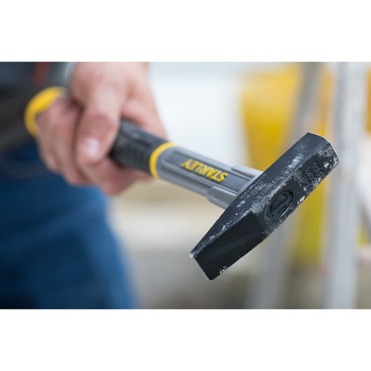 Photo of STANLEY STHT0-51906 chisel hammer with black and yellow handle held in a hand.