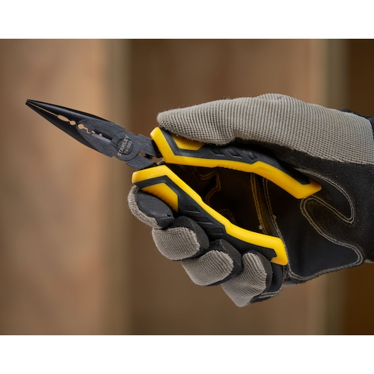 Photo of STANLEY STHT0-74364 pliers with yellow and black handle held by gloved hand.
