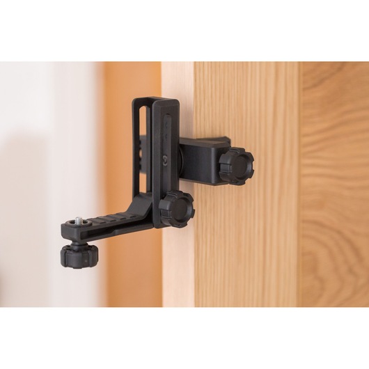 STANLEY STHT77592-1 photography clamp mount attached to wooden door, black adjustable design.