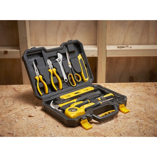 STANLEY STHT78050-1 tool set photography on workbench, includes pliers, hammer, level, utility knife, and screwdriver.