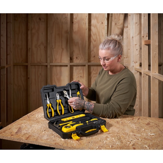 STANLEY STHT78050-1 tool kit with yellow-handled pliers and measuring tools on workbench, indoor photography.