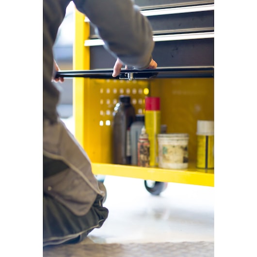 STANLEY STMT1-74305 photography of yellow tool cabinet open with various containers inside, side angle.