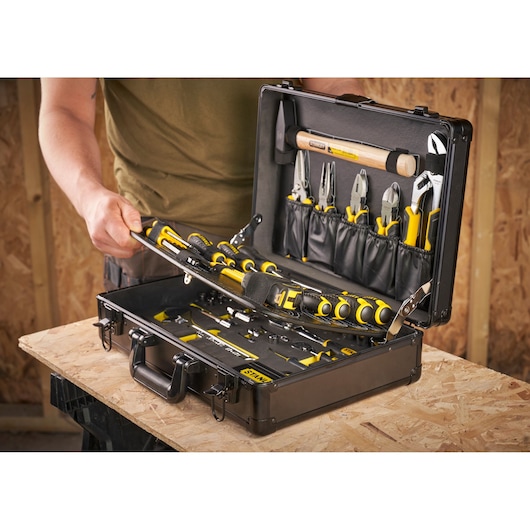 STANLEY STMT72986-1 tool case with yellow-black hand tools, open on workbench, front angle.